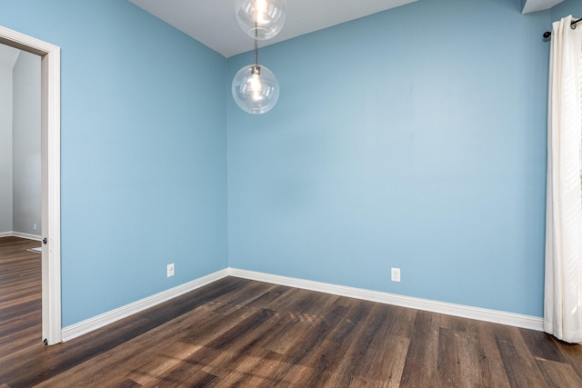 unfurnished room with dark wood-type flooring