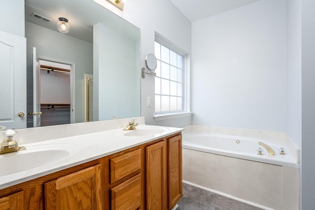 bathroom with a bathtub, tile patterned flooring, and vanity