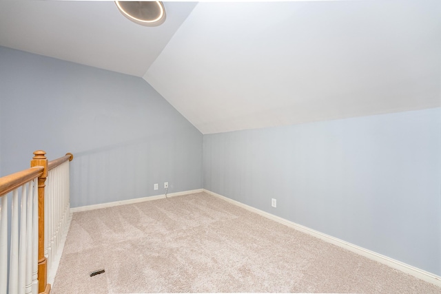 bonus room featuring light colored carpet and lofted ceiling