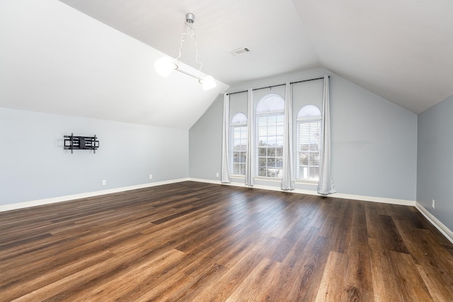 bonus room featuring dark hardwood / wood-style floors and lofted ceiling