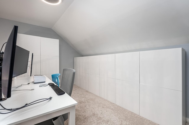 carpeted office with lofted ceiling