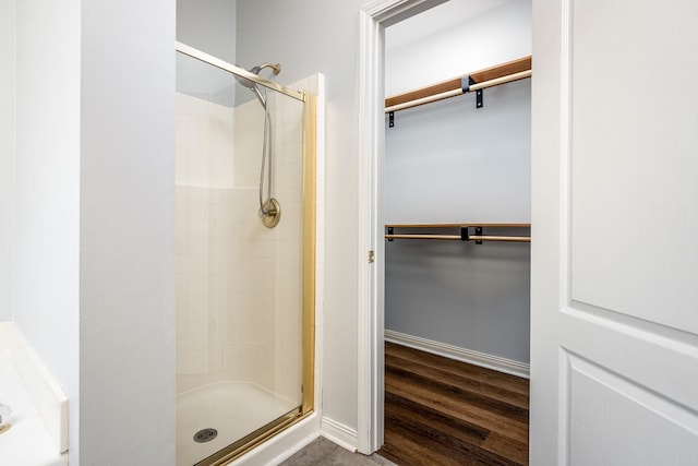 bathroom featuring walk in shower and hardwood / wood-style floors