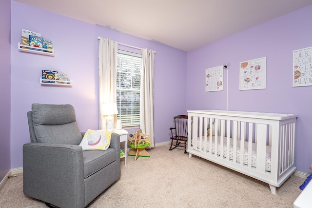 carpeted bedroom featuring a crib