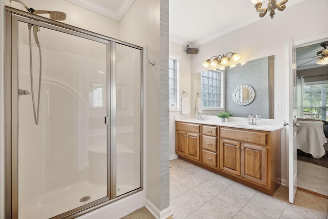 bathroom featuring ornamental molding, a healthy amount of sunlight, an enclosed shower, and vanity