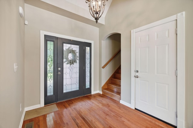 foyer with a notable chandelier and light hardwood / wood-style floors