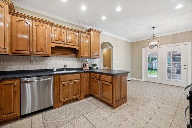 kitchen featuring tasteful backsplash, dishwasher, sink, pendant lighting, and light tile patterned flooring