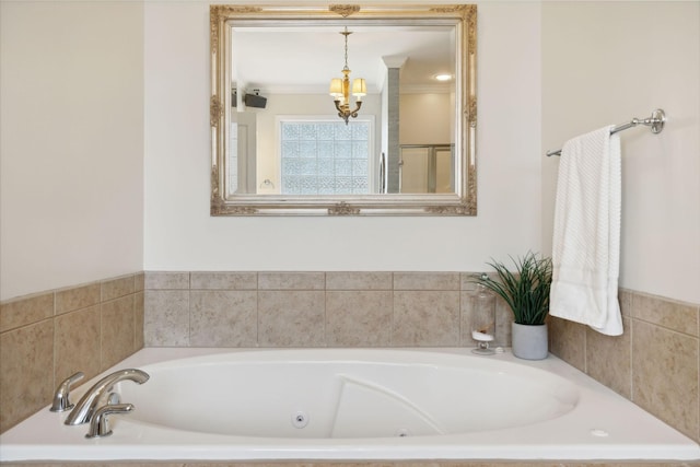 bathroom with a notable chandelier and a bathing tub