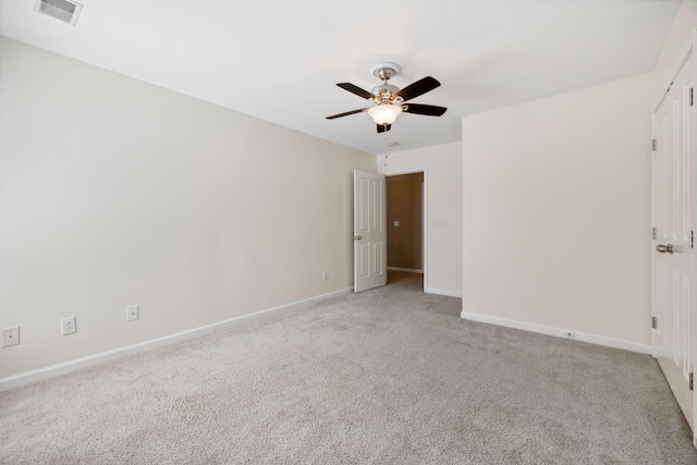 carpeted spare room with ceiling fan