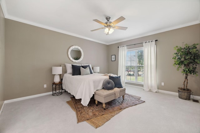 carpeted bedroom with ceiling fan and ornamental molding