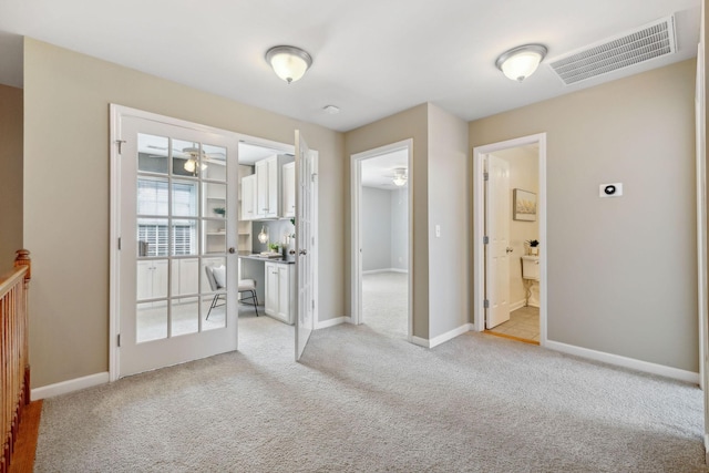 interior space featuring ceiling fan and light carpet