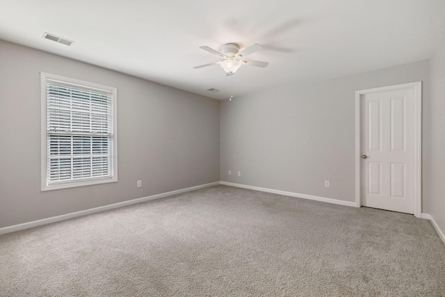 unfurnished room featuring ceiling fan and carpet