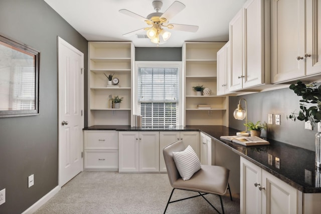 carpeted home office with ceiling fan