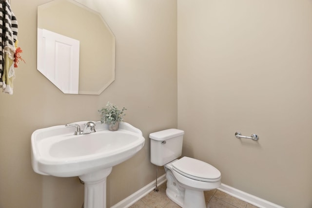 bathroom featuring sink, toilet, and tile patterned floors