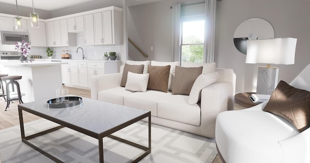 living room with sink and light hardwood / wood-style flooring