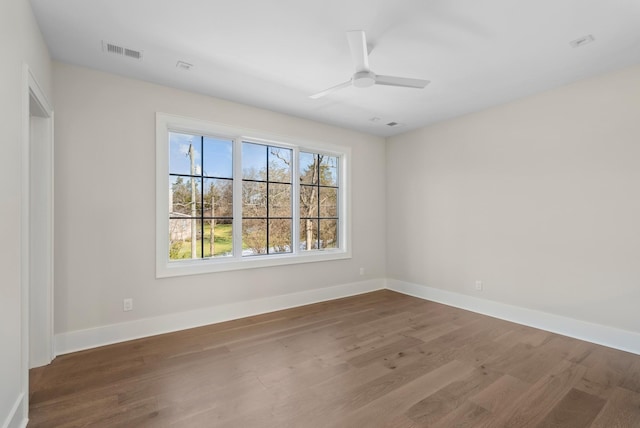 unfurnished room with dark hardwood / wood-style floors and ceiling fan