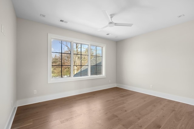 unfurnished room with ceiling fan and wood-type flooring