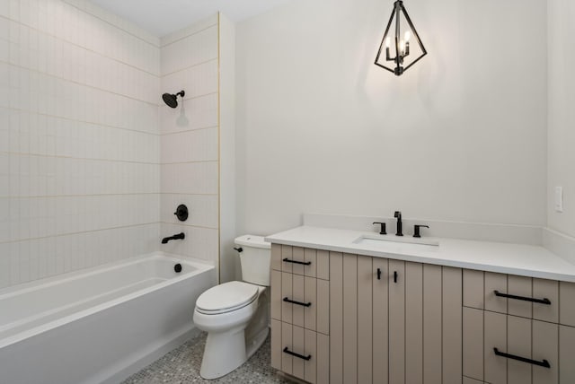 full bathroom featuring tiled shower / bath combo, toilet, and vanity