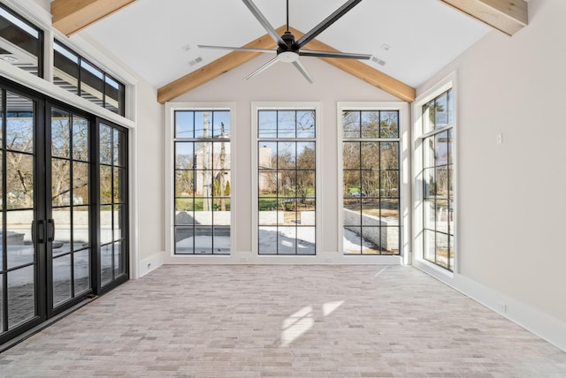 unfurnished sunroom with ceiling fan and lofted ceiling with beams