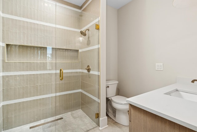 bathroom featuring vanity, toilet, tile patterned floors, and a shower with door