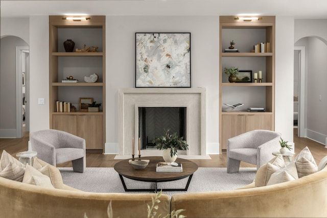 living room with hardwood / wood-style floors and built in features