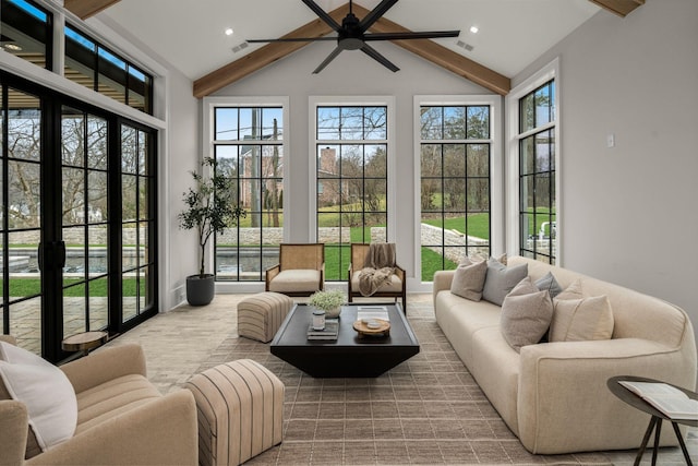 sunroom / solarium with ceiling fan, plenty of natural light, and vaulted ceiling with beams