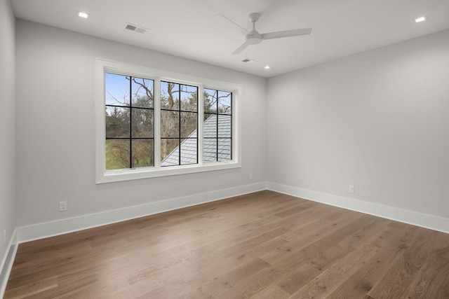 spare room with ceiling fan and wood-type flooring