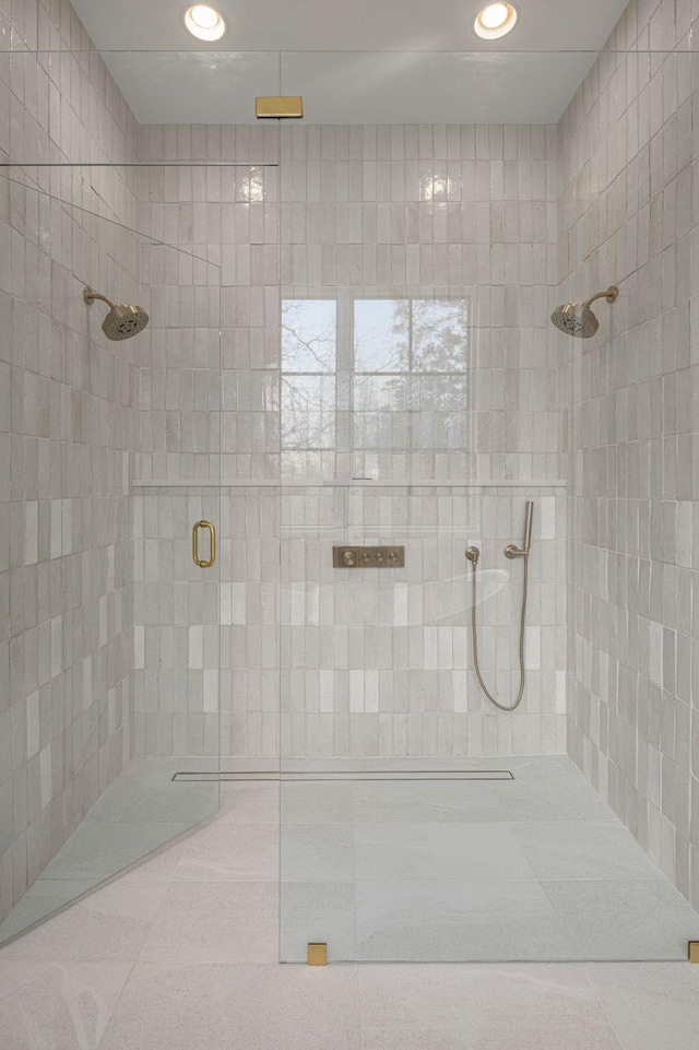 bathroom with a shower with shower door and tile patterned flooring