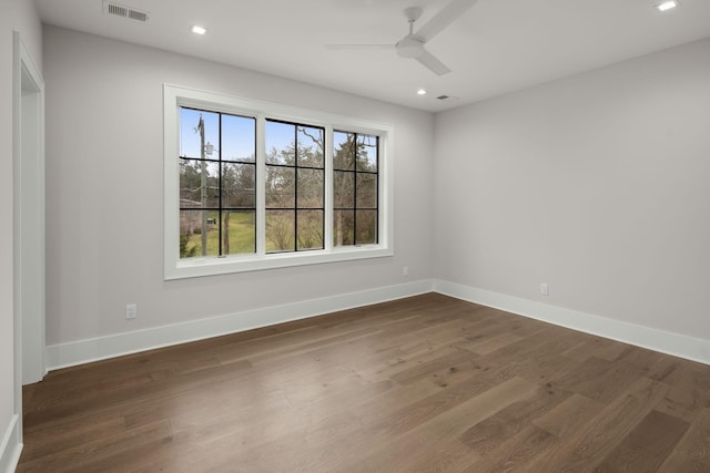 empty room with dark wood-type flooring and ceiling fan