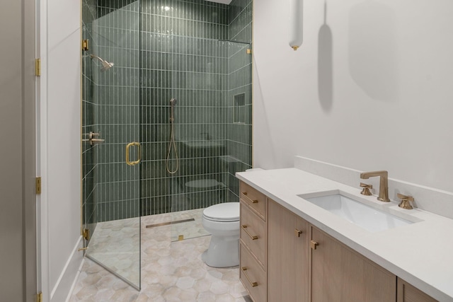 bathroom with vanity, toilet, and a shower with shower door