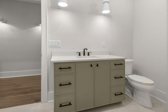 bathroom with vanity, toilet, and wood-type flooring