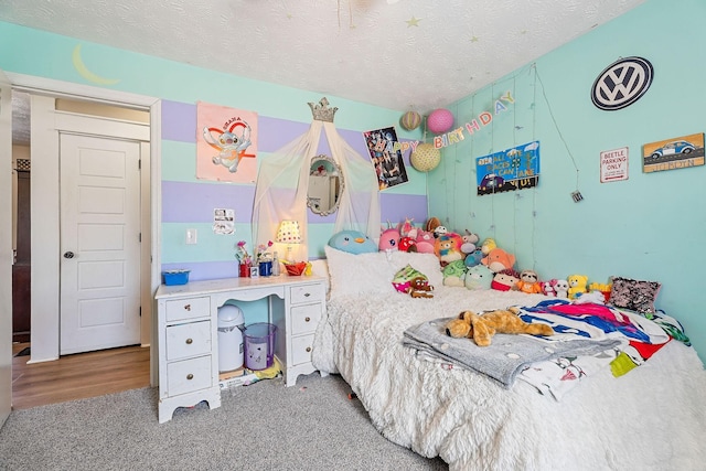 bedroom with carpet floors and a textured ceiling