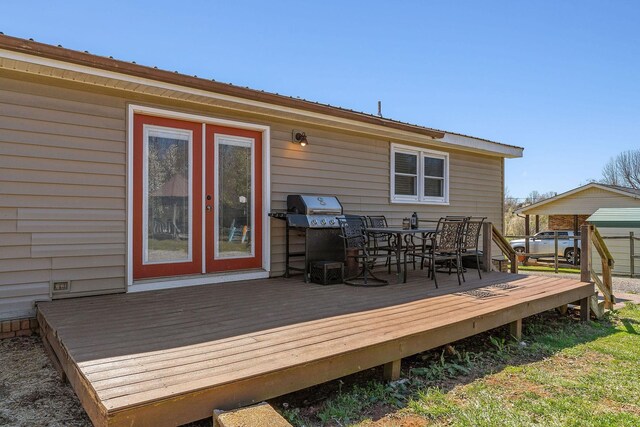 wooden deck with grilling area and outdoor dining area