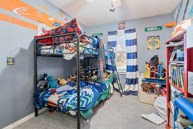 bedroom with baseboards, carpet floors, and a textured ceiling
