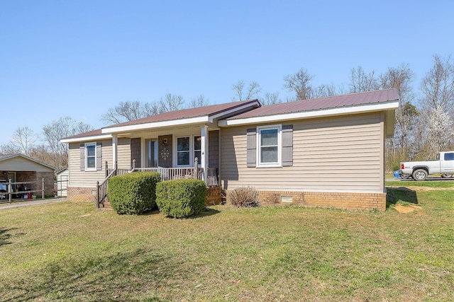 ranch-style home with a porch, crawl space, a front yard, and metal roof