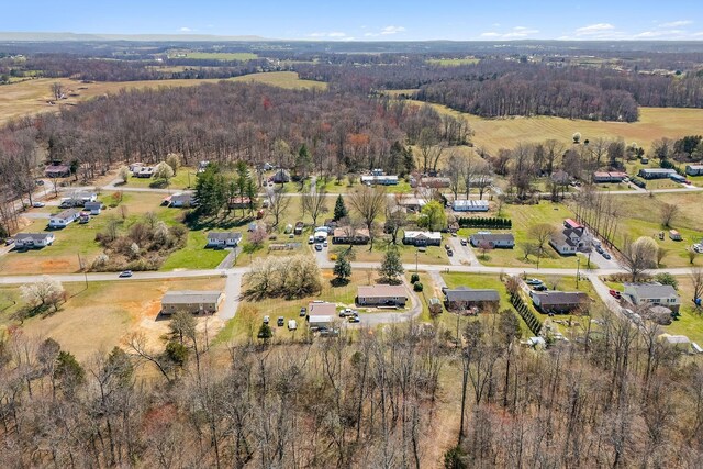 drone / aerial view featuring a forest view
