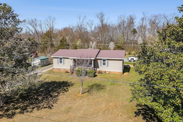 view of front of home with metal roof, a porch, a fenced front yard, and a front yard