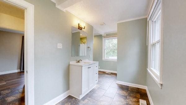 bathroom featuring vanity and ornamental molding