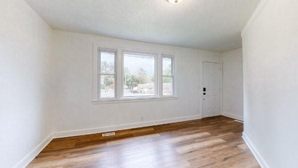 empty room with wood-type flooring