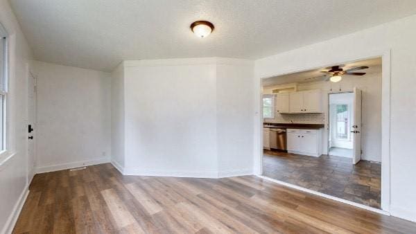 interior space featuring wood-type flooring and ceiling fan