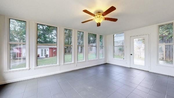 unfurnished sunroom featuring ceiling fan