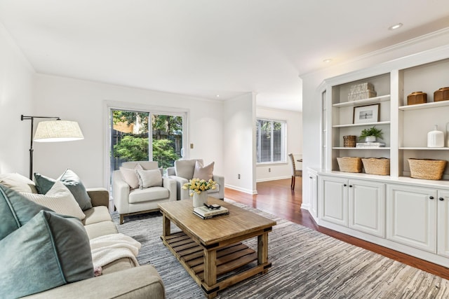 living room featuring crown molding and dark hardwood / wood-style floors