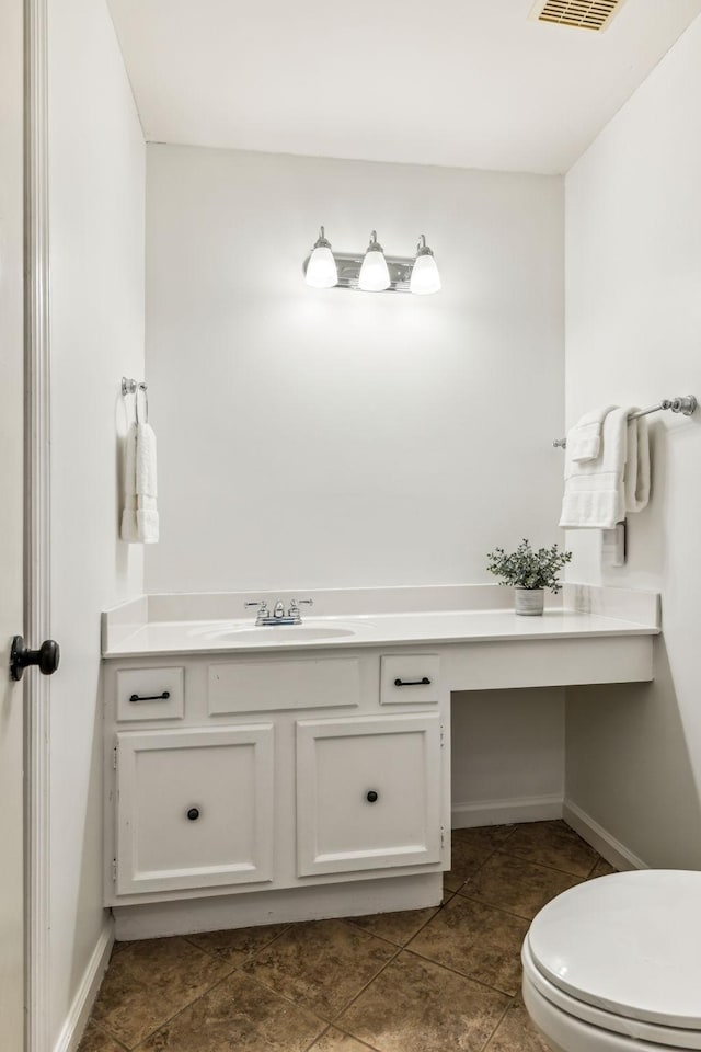 bathroom with vanity, toilet, and tile patterned floors