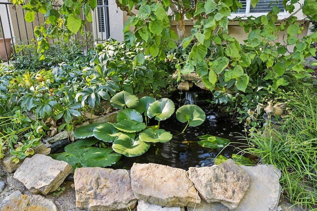 exterior details with a small pond