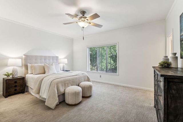 carpeted bedroom with ceiling fan and ornamental molding