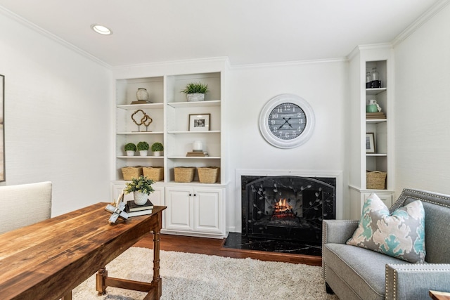 living room with dark wood-type flooring, a high end fireplace, and crown molding