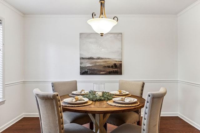 dining space with dark wood-type flooring and ornamental molding