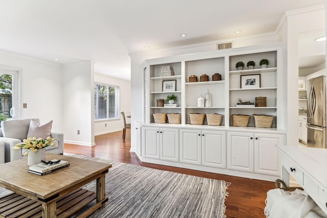 living room featuring dark hardwood / wood-style flooring and ornamental molding