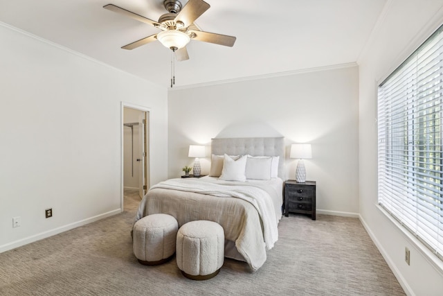 carpeted bedroom featuring ceiling fan and crown molding