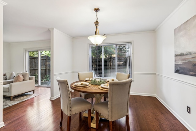 dining area featuring dark hardwood / wood-style floors and crown molding