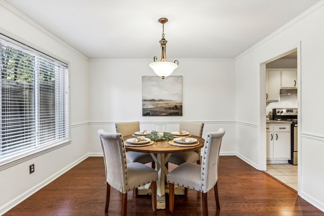 dining space featuring hardwood / wood-style flooring and ornamental molding